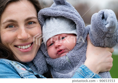 Mom and newborn walk in park Mom and newborn walk in park 90653553