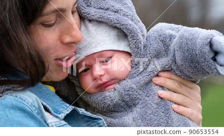 Mom and newborn walk in park 90653554