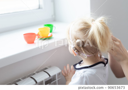 Cochlear implant on baby girl's head. Hearing aid and deafness concept Cochlear implant on baby girl's head. Hearing aid and deafness concept 90653673