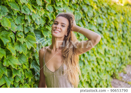 Woman tourist walking in Montenegro. Panoramic summer landscape of the beautiful green Royal park Milocer on the shore of the the Adriatic Sea, Montenegro 90653790