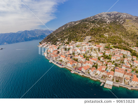 Scenic panorama view of the historic town of Perast at famous Bay of Kotor with blooming flowers on a beautiful sunny day with blue sky and clouds in summer, Montenegro, southern Europe Scenic panorama view of the historic town of Perast at famous Bay of Kotor with blooming flowers on a beautiful sunny day with blue sky and clouds in summer, Montenegro, southern Europe 90653828