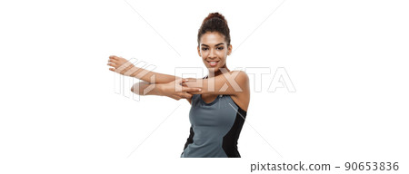 Sport, training, lifestyle and Fitness concept - portrait of beautiful happy African American woman stretching hands. Isolated on white studio background. Sport, training, lifestyle and Fitness concept - portrait of beautiful happy African American woman stretching hands. Isolated on white studio background. 90653836