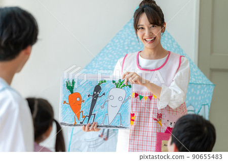 Nursery teacher playing picture-story show 90655483