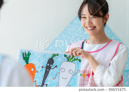 Nursery teacher playing picture-story show Nursery teacher playing picture-story show 90655875