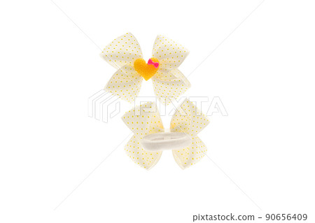 White with yellow dots satin bow for hair for girl, woman isolated on white background. Scrunchie hair clip accessory for girls and women. Close up White with yellow dots satin bow for hair for girl, woman isolated on white background. Scrunchie hair clip accessory for girls and women. Close up 90656409