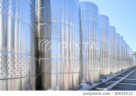 Wine steel tanks, equipment of contemporary winemaker factory. Barrels for wine storage. Equipment for the fermentation, distillation of alcohol. Preparation workshop for pure alcohols. Wine steel tanks, equipment of contemporary winemaker factory. Barrels for wine storage. Equipment for the fermentation, distillation of alcohol. Preparation workshop for pure alcohols. 90656512