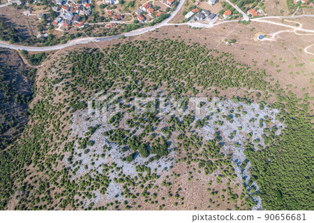 Meandering serpentine road in the mountain with small village house. Aerial view. Copter, drone view 90656681