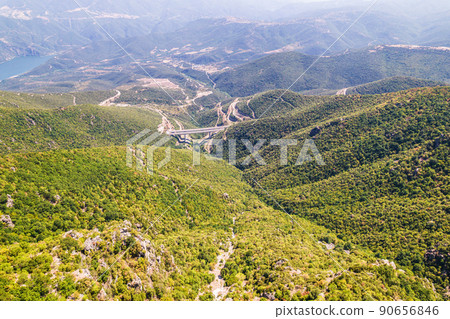 Panoramic view of top of mountains, highway bridge in sunny summer weather in Greece. Aerial view 90656846