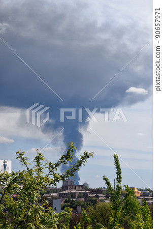 Embankment of the city of Donetsk. A construction crane on the shore. High-rise buildings 90657971