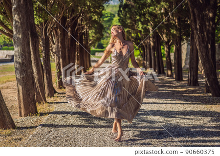 Woman tourist walking in Montenegro. Panoramic summer landscape of the beautiful green Royal park Milocer on the shore of the the Adriatic Sea, Montenegro Woman tourist walking in Montenegro. Panoramic summer landscape of the beautiful green Royal park Milocer on the shore of the the Adriatic Sea, Montenegro 90660375