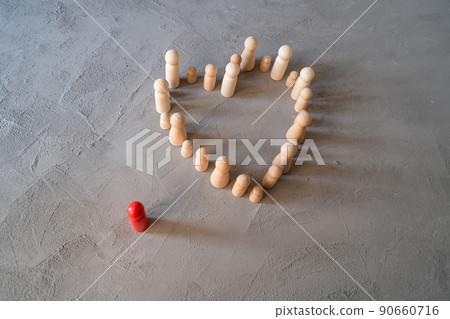 Inclusion. Communication. People stand in a heart on a gray background. Wooden figures of people. Red wooden man. Business team, teamwork, team spirit. society. Flat lay Inclusion. Communication. People stand in a heart on a gray background. Wooden figures of people. Red wooden man. Business team, teamwork, team spirit. society. Flat lay 90660716
