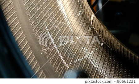 Repair service for wheel tire of car from big puncture. Close view of damaged place marked with chalk Repair service for wheel tire of car from big puncture. Close view of damaged place marked with chalk 90661221