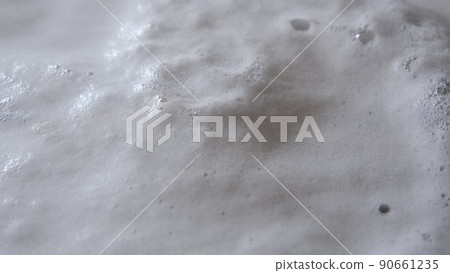 Steam or vapor clouds rising from boiling water with clotted foam and bubbles 90661235