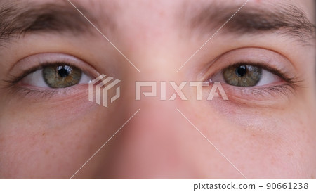 Close up of Man's face. Attractive boy his beautiful green eyes. European young male model looking at camera.extreme 90661238