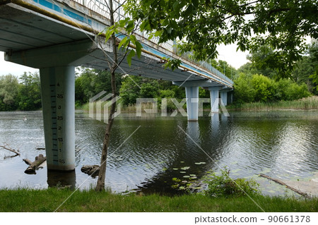 View of Old blue Bridge across Still Waters of River 90661378