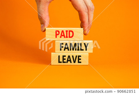 Paid family leave symbol. Concept words Paid family leave on wooden blocks. Doctor hand. Beautiful orange table orange background. Business medical and paid family leave concept. Copy space. 90662851