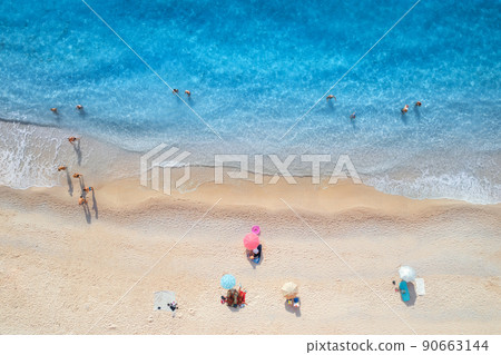 Aerial view of adriatic sea, waves, sandy beach and umbrellas 90663144