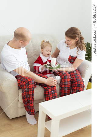 Child girl dressed in christmas dress with cochlear implants having fun at home - diversity and hearing aid and innovating technologies for treatment of deafness. Copy space and place for advertising 90663217