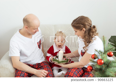 Baby child with hearing aid and cochlear implant having fun with parents in christmas room. Deaf , diversity and health concept 90663225