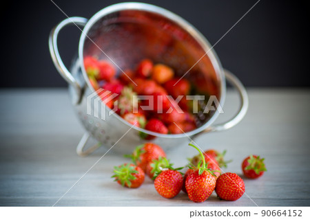 red ripe natural strawberries on a wooden table 90664152