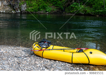 Yellow pack craft placed in the river Yellow pack craft placed in the river 90665531