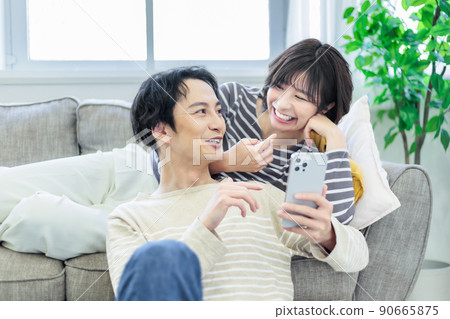 A couple relaxing on the sofa A couple relaxing on the sofa 90665875
