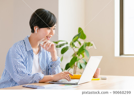 Young woman having a web conference in the living room Young woman having a web conference in the living room 90668299