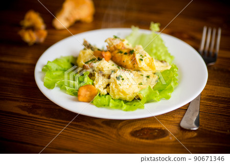 fried omelet with forest mushrooms chanterelles, on table fried omelet with forest mushrooms chanterelles, on table 90671346