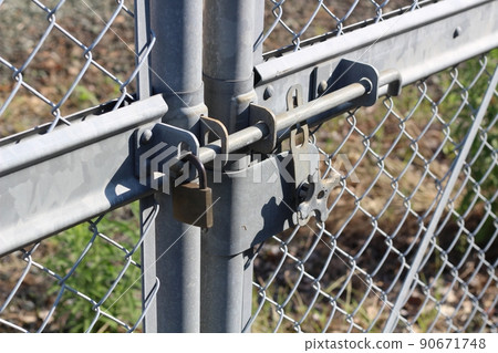 Padlock on fence 90671748