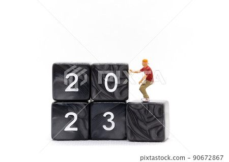 Miniature People Graffiti Artist spraying Number 2023 On Block 90672867