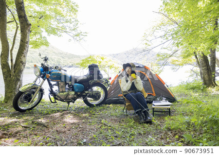 Bike girl chairing image Bike girl doing solo can at the campsite Bike girl chairing image Bike girl doing solo can at the campsite 90673951