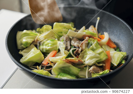 Scene of frying pork and vegetables in a frying pan Scene of frying pork and vegetables in a frying pan 90674227