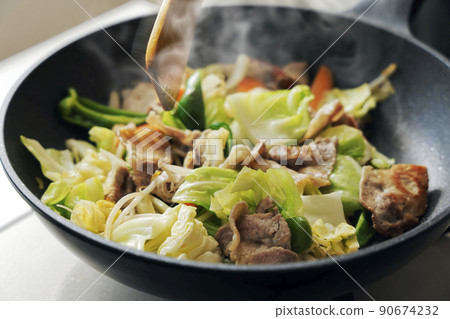 Scene of frying pork and vegetables in a frying pan Scene of frying pork and vegetables in a frying pan 90674232