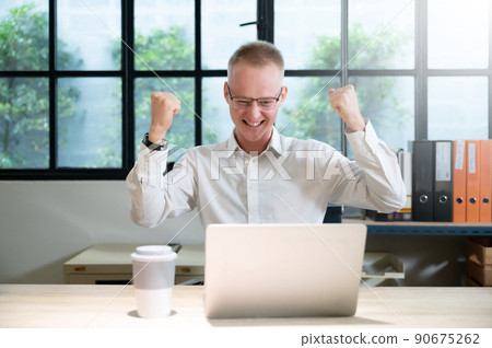 Businessman feeling euphoric celebrating online win success achievement result Businessman feeling euphoric celebrating online win success achievement result 90675262