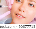 Image of a young beautiful woman dressed as a patient, lying on a couch in a cosmetology clinic. 90677713