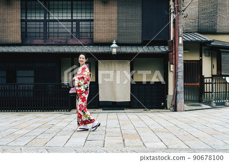 A young woman walking around Kyoto in a kimono A young woman walking around Kyoto in a kimono 90678100