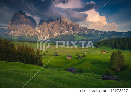 Summer alpine landscape and wooden chalets on the meadows, Dolomites Summer alpine landscape and wooden chalets on the meadows, Dolomites 90678317