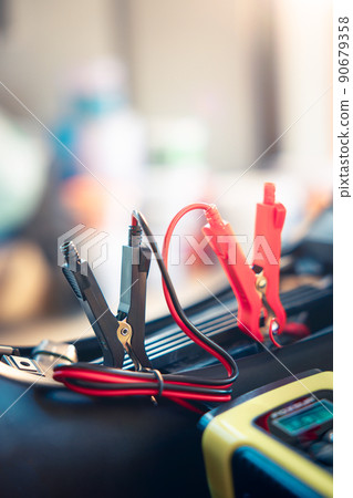 Charging battery and repair in motorcycle for start by portable trickle charger and clamp. Charging battery and repair in motorcycle for start by portable trickle charger and clamp. 90679358