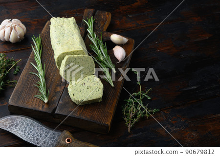 Homemade Organic Herb Butter with Rosemary Thyme and garlic, on old dark wooden table background, with copy space for text Homemade Organic Herb Butter with Rosemary Thyme and garlic, on old dark wooden table background, with copy space for text 90679812