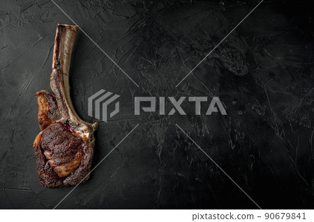Grilled tomahawk beef steak, on black stone background, top view flat lay, with copy space for text Grilled tomahawk beef steak, on black stone background, top view flat lay, with copy space for text 90679841