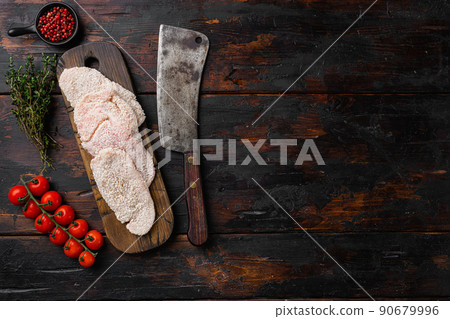 Homemade raw breaded German Weiner Schnitzel set, on old dark wooden table background, top view flat lay, with copy space for text Homemade raw breaded German Weiner Schnitzel set, on old dark wooden table background, top view flat lay, with copy space for text 90679996