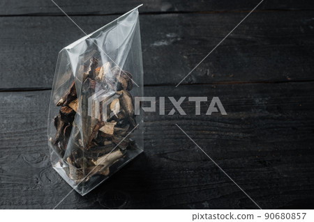 Dried wild mushrooms, on black wooden table background, in plastic pack , with space for text copyspace Dried wild mushrooms, on black wooden table background, in plastic pack , with space for text copyspace 90680857