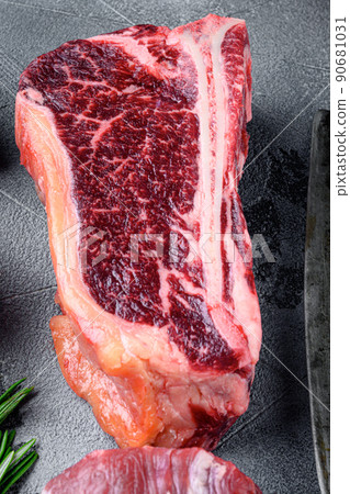 Club steak raw marbled beef meat, on gray stone background 90681031