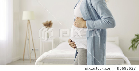 Crop shot of pregnant woman touch big belly 90682628