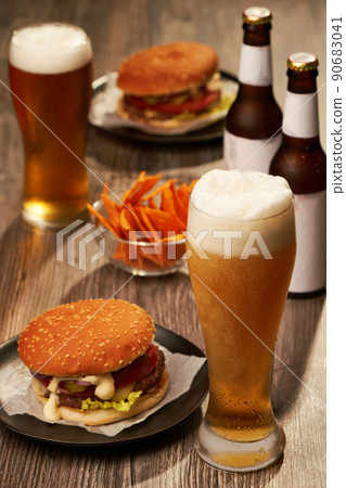 Bottles and glasses of beer with hamburgers 90683041