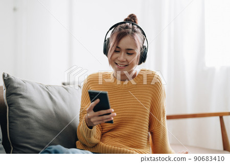 Positive cheerful asian girl have online video call broadcast meet bloggers say hi wave hand sit table use laptop in house indoors. Positive cheerful asian girl have online video call broadcast meet bloggers say hi wave hand sit table use laptop in house indoors. 90683410