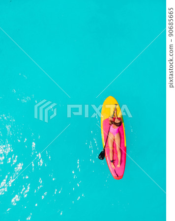 Sexy woman on SUP board at blue ocean in summer day Sexy woman on SUP board at blue ocean in summer day 90685665