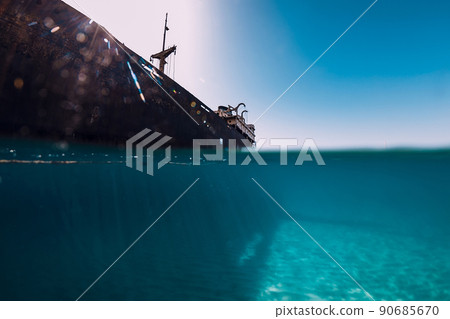 Telamon wreckship in blue ocean. Split shot. Arrecife, Lanzarote 90685670