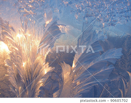 Ice pattern and sunlight close up on window glass early in the morning Ice pattern and sunlight close up on window glass early in the morning 90685702