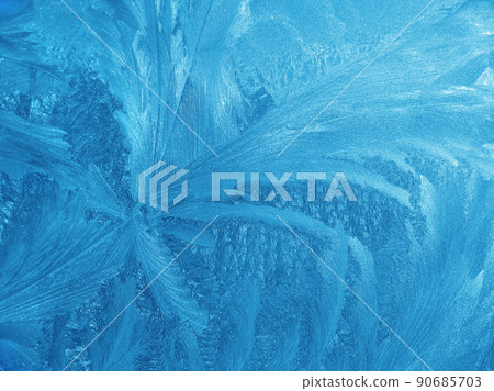 Beautiful ice pattern closeup on window glass Beautiful ice pattern closeup on window glass 90685703